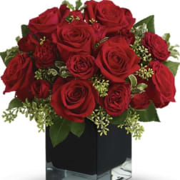 Red roses arranged in a black square vase