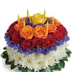 Round bouquet of red and orange roses with white chrysanthemums and yellow candles