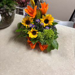 Bright mixed bouquet with sunflowers, orange lilies, and purple accents