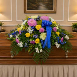 Colorful funeral spray on a casket with a blue ribbon