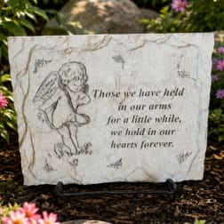 Memorial stone with an angel and sympathy quote on a stand