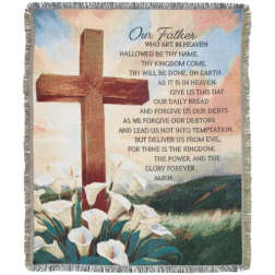Fringed blanket with a cross, calla lilies, and the Lord's Prayer text