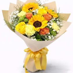 Bouquet of yellow sunflowers and roses wrapped in beige paper with a yellow ribbon