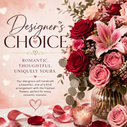 Pink and red rose bouquet with a lily in a glass vase