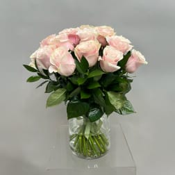 Bouquet of pale pink roses in a clear glass vase