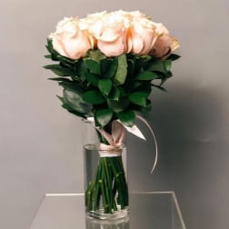 Bouquet of pale pink roses in a clear glass vase
