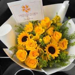 Yellow roses and sunflowers in white wrapping
