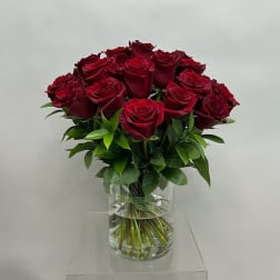 Bouquet of deep red roses in a clear glass vase
