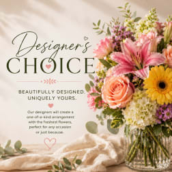 Mixed bouquet in a clear glass vase with pink lily, rose, gerbera, and hydrangea blooms