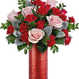 Red and pale pink roses in a red vase