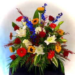 Colorful mixed flower arrangement with roses, lilies, and gerbera daisies