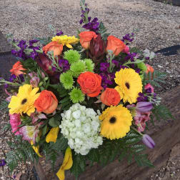 Colorful mixed bouquet with orange roses, yellow gerberas, and white hydrangea
