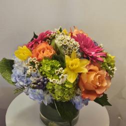 Colorful mixed flower arrangement in a glass vase