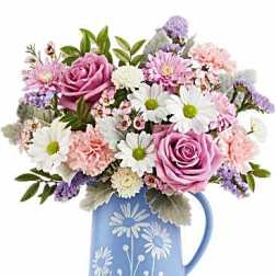 Pink and white mixed bouquet in a blue floral pitcher