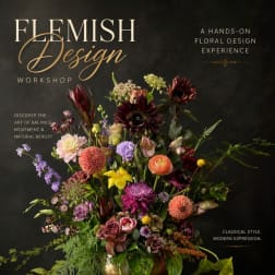 Large mixed floral arrangement in a vase with burgundy, pink, purple, and yellow blooms