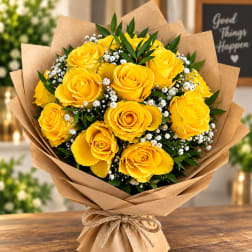 Bouquet of yellow roses with baby's breath in brown paper wrap