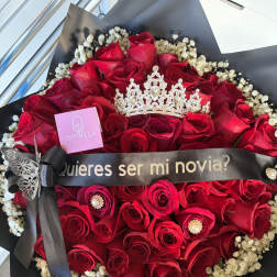 Red rose bouquet with baby's breath, black wrap, and a decorative crown