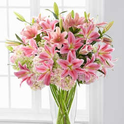 Pink lilies arranged in a clear glass vase