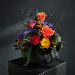 Halloween bouquet with orange roses, purple flowers, and striped witch hats