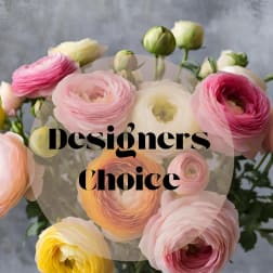 Bouquet of pink, white, and yellow ranunculus in a glass vase