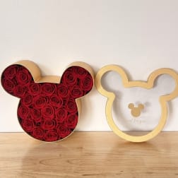 Red roses arranged in a Mickey Mouse-shaped box beside an empty matching frame