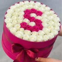 Round box of white and hot pink roses with a ribbon bow