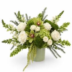 White roses and green orchids in a pale green vase