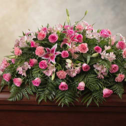 Pink floral casket spray with roses, lilies, and carnations