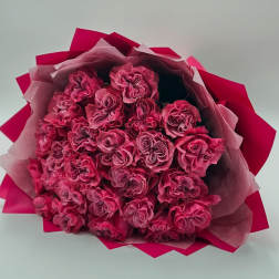 Bouquet of pink roses wrapped in pink paper