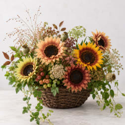 Basket arrangement with sunflowers and mixed autumn flowers