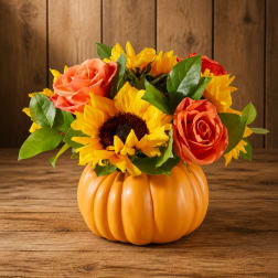 Sunflower and rose arrangement in an orange pumpkin container