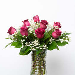 Pink roses and baby's breath in a clear glass vase