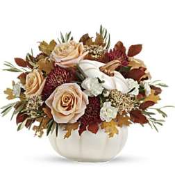Autumn floral arrangement with roses and white pumpkins in a white vase