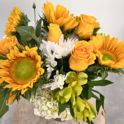 Bouquet of yellow sunflowers, roses, and white flowers