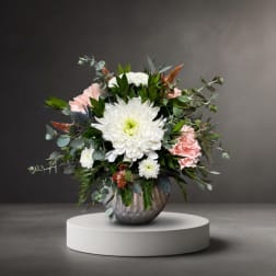 White and pink floral arrangement in a metallic vase