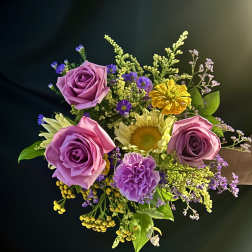 Bouquet of pink and purple roses with yellow and lavender accent flowers