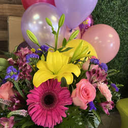 Bright mixed bouquet with yellow lily, pink gerbera, roses, and balloons