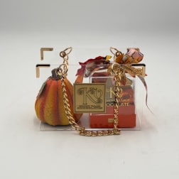 Gift basket with chocolates in a clear acrylic box and a decorative pumpkin pouch