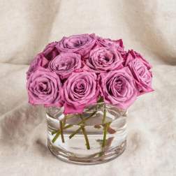 Pink roses arranged in a clear glass vase