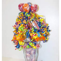 Candy bouquet in a clear glass vase with colorful curled ribbons