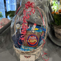 Gift basket with snack bags wrapped in clear plastic and red ribbon