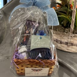 Gift basket with hair clip, lotion, and other small items wrapped in clear plastic