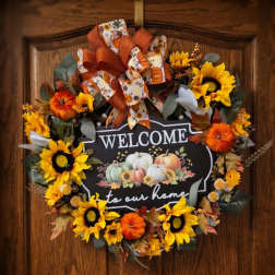 Fall wreath with sunflowers and pumpkins around a welcome sign