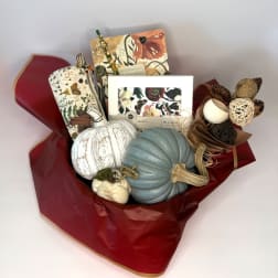 Gift bouquet with decorative pumpkins, notebook, and candle set in red wrap