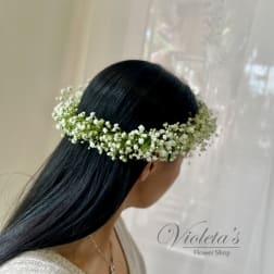 Woman wearing a white baby's breath flower crown in her hair