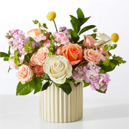Mixed pink, peach, and white roses in a striped vase