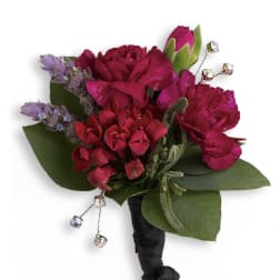 Small magenta boutonniere with green leaves and dangling crystal accents