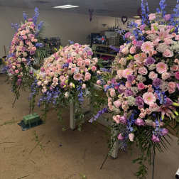 Large floral sprays in pink, lavender, and blue on stands