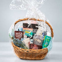 Gift basket with snacks and self-care items wrapped in clear plastic