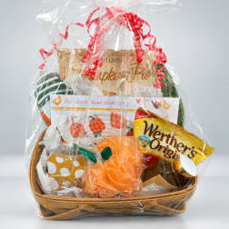 Gift basket with kitchen items and snacks wrapped in clear cellophane